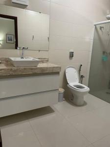 a bathroom with a sink and a toilet and a shower at Chácara Jatobá in Espirito Santo Do Pinhal +19 photos