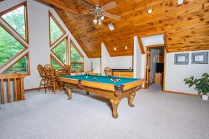 a room with a pool table in a house at Lake Dreaming in McHenry