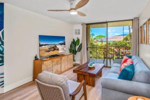 a living room with a couch and a table at Hip Hawaiian Oceanfront Vistas in Kihei