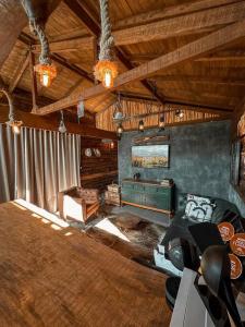 a living room with a couch and a tv at Cabanas do Paiol Texas Cabin Toledo MG in Toledo