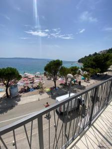 a balcony with a view of a beach and the ocean at Leandra in Baška Voda
