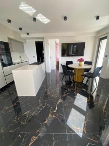 a kitchen and dining room with a table and chairs at Leandra in Baška Voda