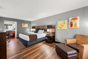 a hotel room with a bed and a chair at Best Western Corbin Inn in Corbin +37 photos