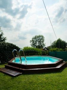 a swimming pool in the grass with two handles at Casa Fornace 28 in La Morra