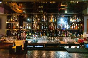 a bar with a lot of bottles of alcohol at Best Western La Vista Pathankot in Pathānkot