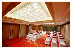 a room with rows of white chairs and a skylight at Best Western Plus Tejvivaan in Visakhapatnam