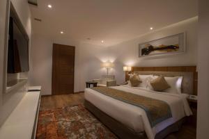 a hotel room with a bed and a television at Best Western Plus Tejvivaan in Visakhapatnam