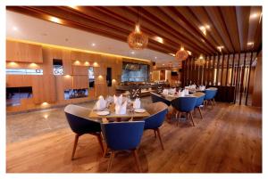 a restaurant with tables and chairs in a room at Best Western Plus Tejvivaan in Visakhapatnam