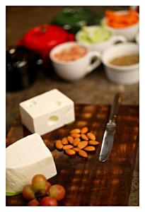a cutting board with cheese and nuts and a knife at Best Western Plus Tejvivaan in Visakhapatnam