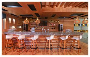 a bar with white bar stools in a restaurant at Best Western Plus Tejvivaan in Visakhapatnam