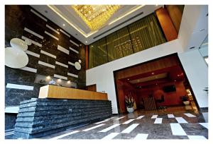 a lobby of a hotel with a stone wall at Best Western Plus Tejvivaan in Visakhapatnam