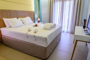 Postel nebo postele na pokoji v ubytování Ionion Beach Apartment Hotel & Spa