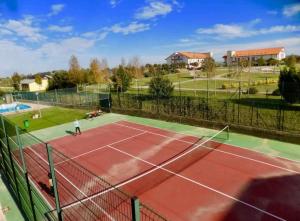 a tennis court with a person standing on it at Atico en Ajo Cantabria in Ajo