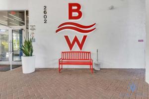a red bench sitting in front of a w sign at Amazing Studio Infinity View Balcony in Hallandale Beach +40 photos