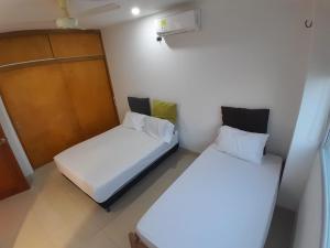 Postel nebo postele na pokoji v ubytování Tolú mágico, apartamentos amoblados con vista al mar, Elegancia y comodidad + 75 fotografií