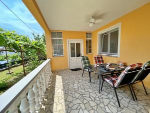 a patio with a table and chairs on a balcony at Apartments with parking space Silo, Krk - 18757 in Šilo