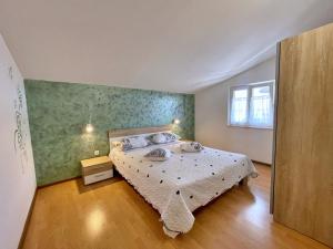 a bedroom with a bed and a window at Apartments with parking space Silo, Krk - 18757 in Šilo