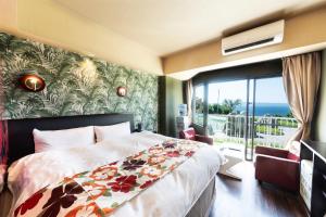 a bedroom with a bed and a large window at Nagasaki Chapel Coconuts Hotel ＆Resort in Isahaya