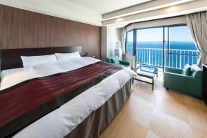 a bedroom with a large bed and a balcony at Nagasaki Chapel Coconuts Hotel ＆Resort in Isahaya