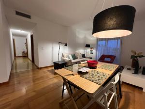 a living room with a table and a couch at Apartamento do Atlântico in Ponta Delgada +20 photos