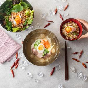 a table with a bowl of soup and a bowl of food at Nagasaki Chapel Coconuts Hotel ＆Resort in Isahaya