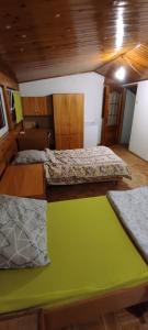 a room with two beds and a green table at Adam room piwnica in Wrocław +6 photos