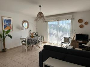 a living room with a couch and a table at Charmant T2 climatisé à Biscarrosse Plage, à 2 min de la mer, avec balcon et parking inclus - FR-1-319-392 in Biscarrosse-Plage