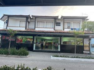 a store front of a building with glass windows at Brothers Suites Centro Búzios in Búzios