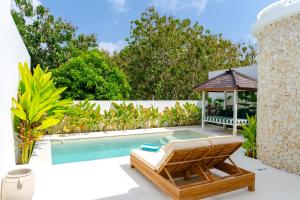 a villa with a swimming pool and a gazebo at Sonnys Uluwatu in Uluwatu