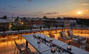 a patio with a table and chairs on a roof at Graduate Oxford in Oxford