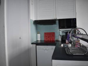 une cuisine avec un évier et un plan de travail dans l'établissement Studio Cabine 4 Pers. - Exposé Plein Sud - FR-1-580-117, à Font-Romeu-Odeillo-Via