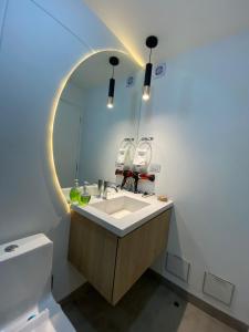 a bathroom with a sink and a mirror at DEPARTAMENTO KILLA HUATANA in Cusco