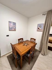 a dining room with a wooden table and chairs at شقة فندقية بمدينتي in Cairo +8 photos