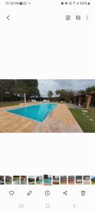 a screenshot of a webpage with a picture of a swimming pool at Casa da Felicidade in Ibiúna +8 photos