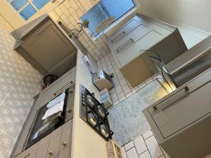 an overhead view of a kitchen with a stove at Beautiful Bungalow in Plymouth