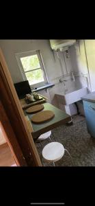 a kitchen with two stools and a sink and a counter at Charmant chalet in Auffargis