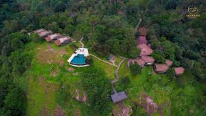 an aerial view of a house with a boat in the forest at Haze and Kites Resort Munnar in Munnar