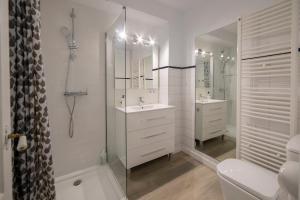 a white bathroom with two sinks and a shower at Sant Ferriol in Olot +53 photos