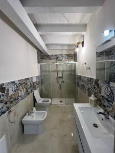 a bathroom with a shower and a toilet and a sink at Terrasini Sea in Terrasini +31 photos