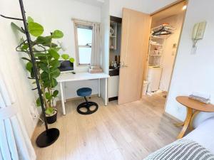 a room with a desk with a computer and a plant at シャンテ高田馬場22 in Tokyo