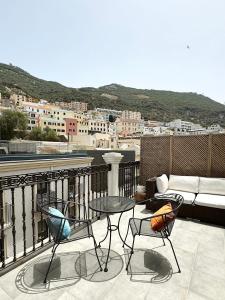 a balcony with a couch and chairs and a table at Grand Central House - Luxe Penthouse Two Bedroom - GibraltarStay Apartments in Gibraltar