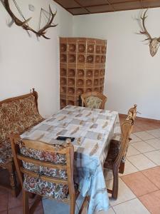 a dining room with a table and two chairs at Zanati Apartmannház in Nagykapornak