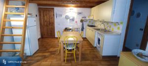 a small kitchen with a wooden table and a ladder at Appartamento Pietro direttamente sul mare di costa smeralda in Olbia +14 photos