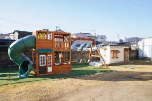 ein Spielplatz mit Rutsche im Hof in der Unterkunft 香川県高松市中心部で駐車6台無料の家族向けゲストハウス in Takamatsu