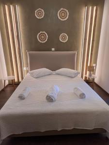 a large white bed with two slippers on it at Irene' s Place in Olympia