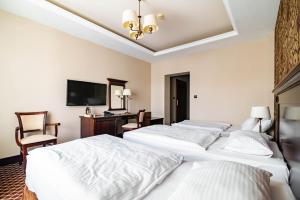 Posteľ alebo postele v izbe v ubytovaní Hotel Wileński