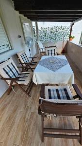 a room with chairs and a bed on a balcony at Sea Side View in Dhíkella +29 photos
