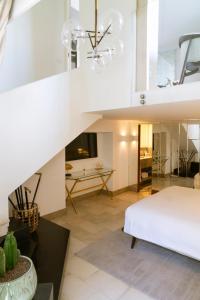 a large white bedroom with a bed and a table at Villa Marina Capri Hotel & Spa in Capri