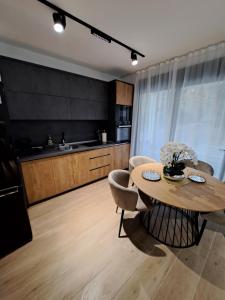 a kitchen with a table and chairs in a room at Apartments Pepdjonovic in Ulcinj
