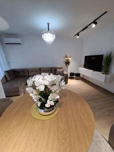 a living room with a vase of flowers on a table at Apartments Pepdjonovic in Ulcinj
